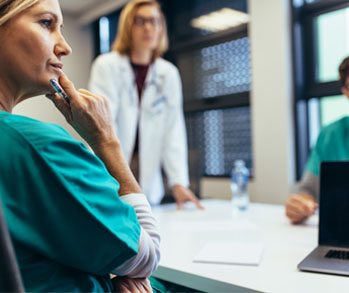 Doctors conversing in a hospital conference room.