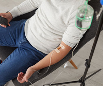 Youthful man sitting in a chair getting an IV