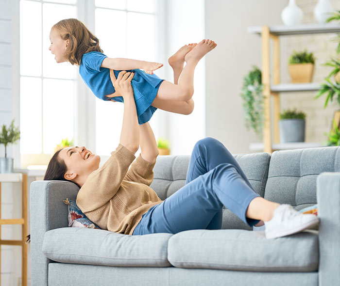 Woman with healthy heart enjoys playing with her kid